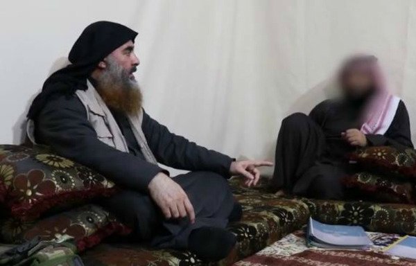 ISIS chief Abu Bakr al-Baghdadi is seen speaking to an aide in a still from a video released April 29th by the group's media arm, Al-Furqan.