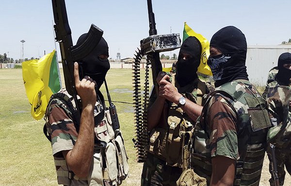 Members of Kataib Hizbullah, one of the largest Iran-backed militias in Iraq, pose with weapons in an undated photo circulated on social media.
