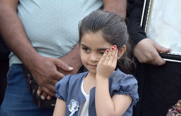 A young girl stands with family members as they take part in a July 4 vigil for victims of the Beirut port blast. [Ziad Hatem]