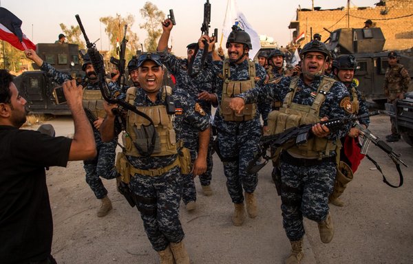 Members of the Iraqi forces celebrate in the Old City of Mosul on July 10, 2017, after the government's announcement of the 'liberation' of the embattled city from ISIS. [Fadel Senna/AFP]