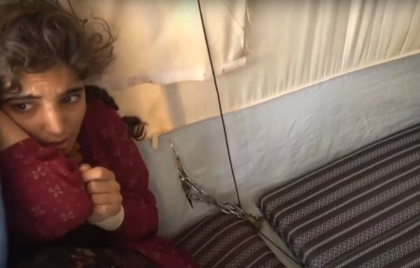 During a security sweep of al-Hol camp, security forces found a girl shackled inside a tent. She is shown in a screenshot from an SDF video posted June 9.